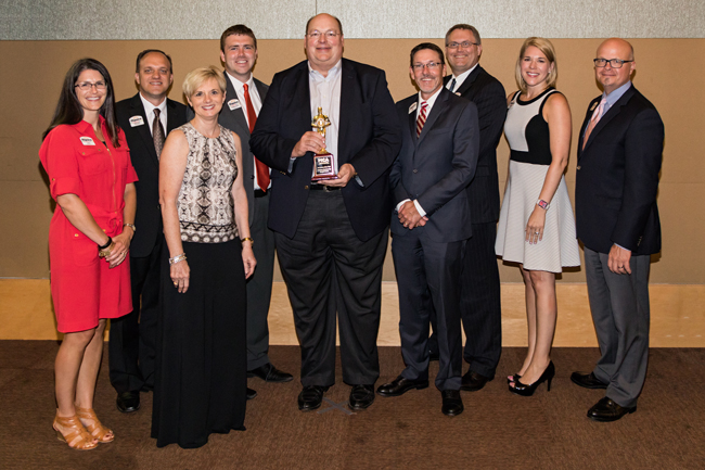 Dupaco group poses with the Dubuque Chamber's Business of the Year award.
