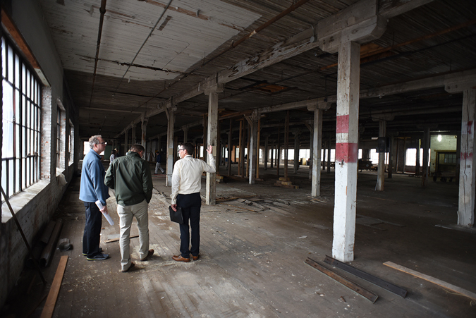 Voices project participants assess the building’s dilapidated fifth floor interior.